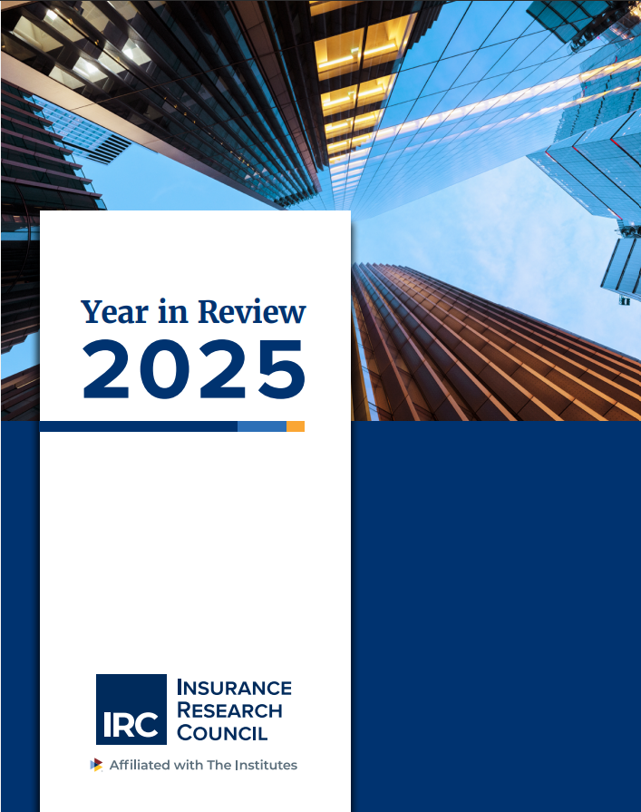 IRC 2025 Year in Review report cover, featuring an upward view of glass office towers against a blue sky, with the Insurance Research Council logo and 'Affiliated with The Institutes' tagline.