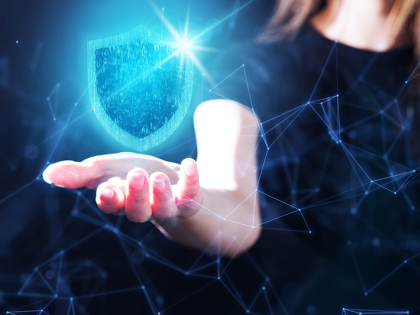 Insurtech concept of a woman with an outstretched hand and a digital shield overing above it. 